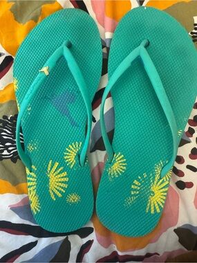 Freewaters Teal Flip Flops with Yellow Sunburst Print and gold bird accent